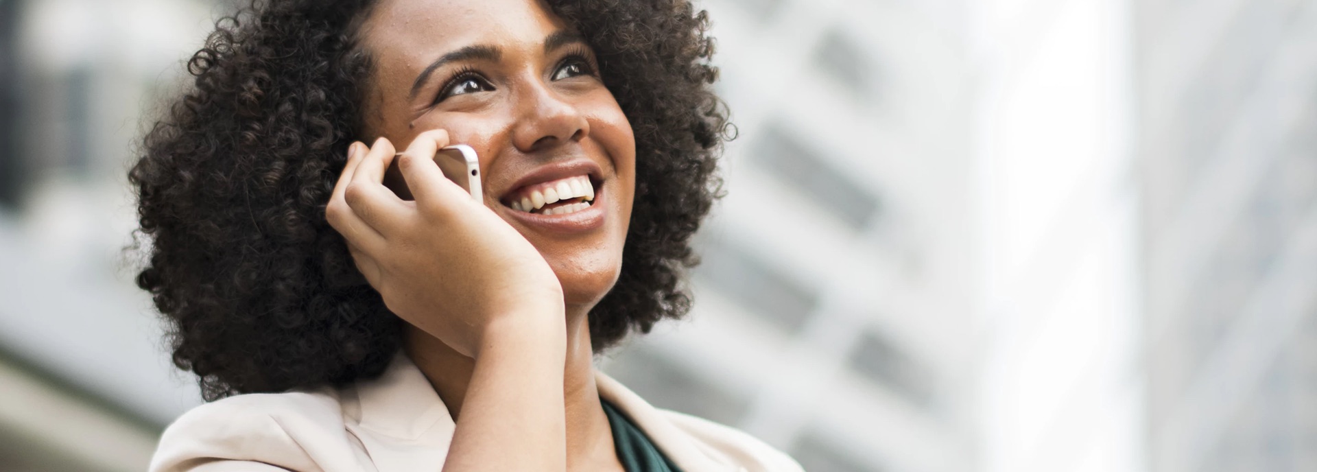 A woman talking on her cellphone with excitement